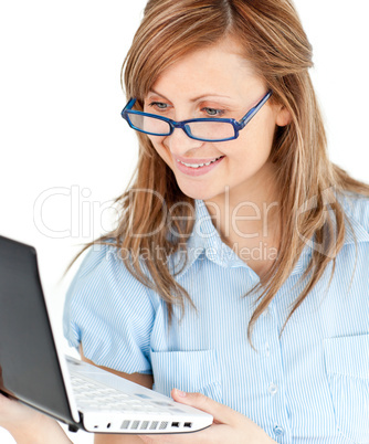 Ambitious businesswoman standing using her laptop