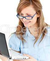 Ambitious businesswoman standing using her laptop