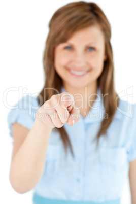 Smiling blond woman showing with a finger at the camera