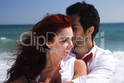 young couple enjoying on the beach beautiful