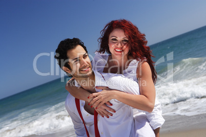 young couple enjoying on the beach