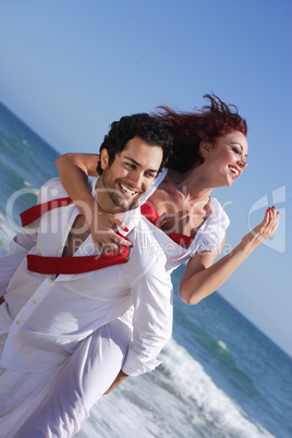 young couple enjoying on the beach