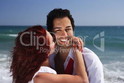 young couple enjoying on the beach flirting