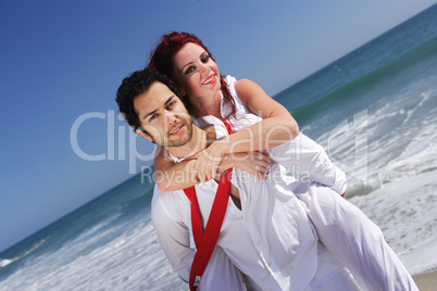 young couple enjoying on the beach