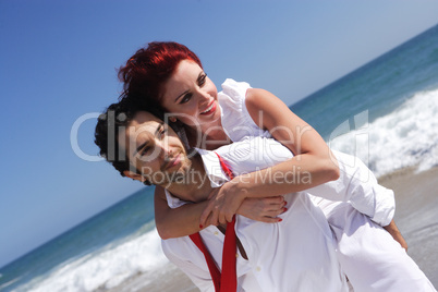 young couple enjoying on the beach