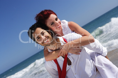 young couple enjoying on the beach