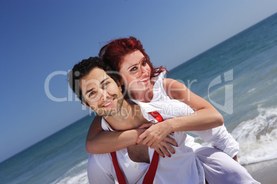 young couple enjoying on the beach