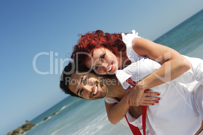 young couple enjoying on the beach