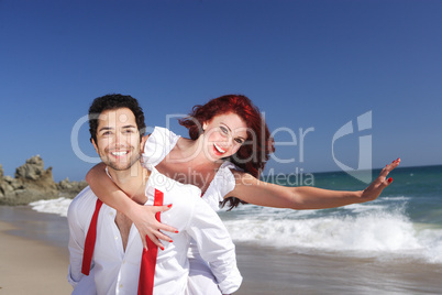 young couple enjoying on the beach