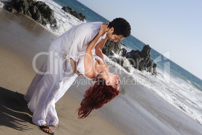 Young Couple at the beach dancing