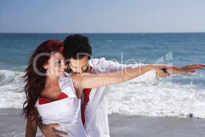 Young Couple at the beach holding hands