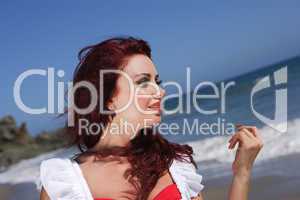 Young woman at the beach near the water