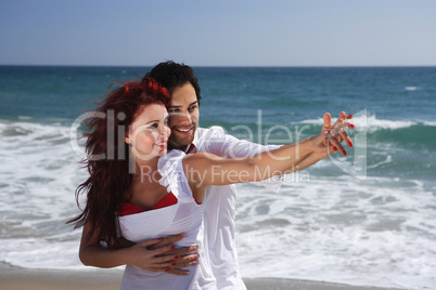 Young Couple at the beach holding hands