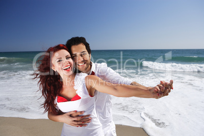 Young Couple at the beach holding hands
