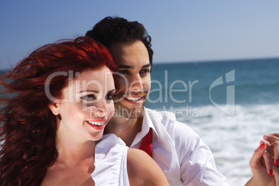 Young Couple at the beach holding hands close up
