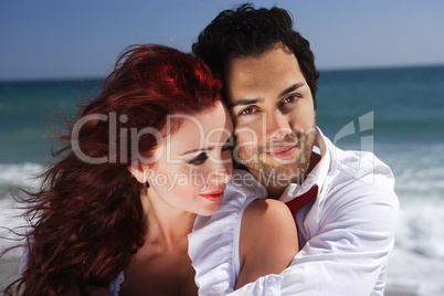 Romantic couple holding each other at the beach