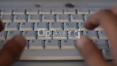 Hands Typing on Keyboard of Laptop