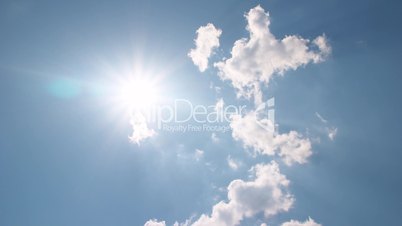White clouds disappear in the hot sun on blue sky