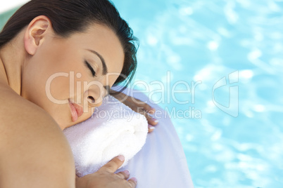Beautiful Young Woman Relaxing By Pool At Health Spa