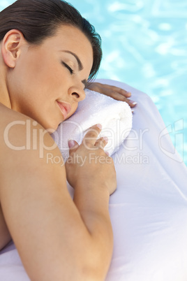 Beautiful Young Woman Relaxing By Pool At Health Spa