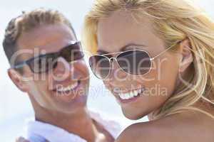 Happy Attractive Woman and Man Couple In Sunglasses At Beach