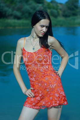 girl in red gown near sea