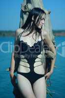 girl in black swimsuit near sea