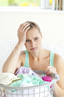 Depressed young woman doing the laundry
