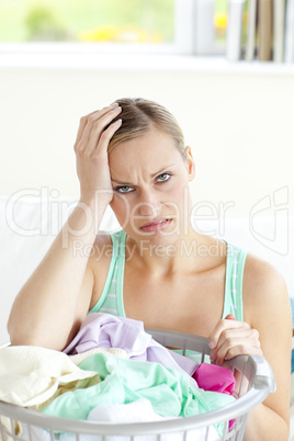Exhausted young woman doing the laundry