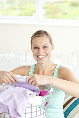 Cheerful young woman doing the laundry