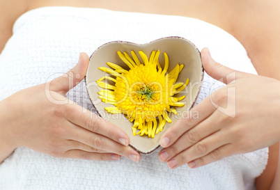 Woman holding a flower in her hands