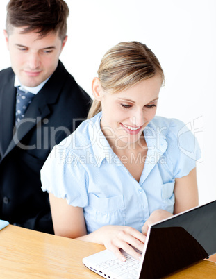 Beautiful young businesswoman using her laptop at home