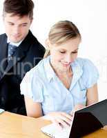 Beautiful young businesswoman using her laptop at home