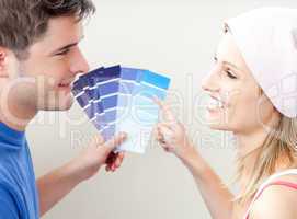 Charming couple choosing color for a room