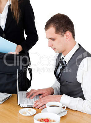 Charming businesswoman standing near the table while her husband