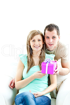 Young boyfriend giving a present to his glowing girlfriend