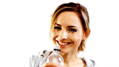 Beautiful girl drinking water from blue bottle