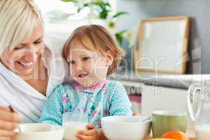 Simper mother having breakfast with her daughter