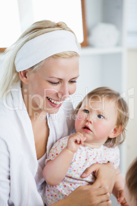 Laughing mother taking care of her children