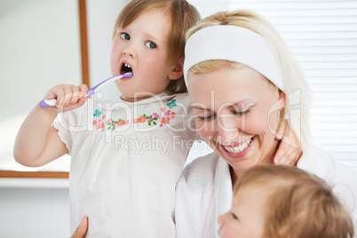 Attractive mother taking care of her children