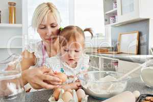 Focused woman baking cookies with her daughter