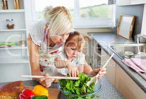 Mother and daughter preparing a salad