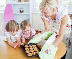 Pretty woman baking cookies with her daughter