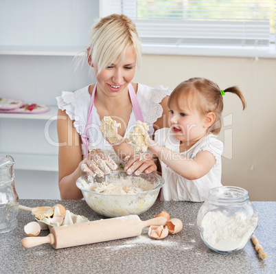 Simper woman baking cookies with her daughter