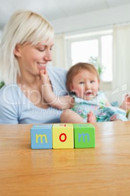 Young mother paying with her daughter