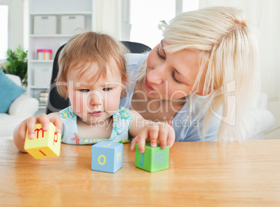 Blond mother paying with her daughter