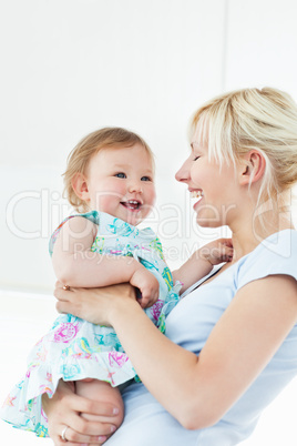 Smiling woman playing with her daughter Smiling woman playing with her daughter