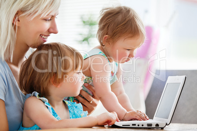 Enthusiastic family having fun with a laptop