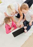 Cute family having fun with a laptop
