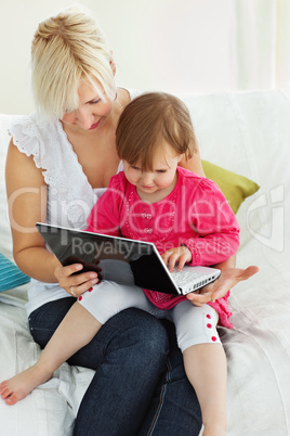 Mother and daughter having fun with a laptop